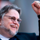 Guillermo del Toro cheering with his fist in the air.